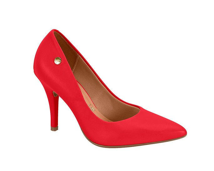 Product shot of a vibrant red high-heeled pump with a gold button detail and a pointed toe featuring a subtle light brown insole