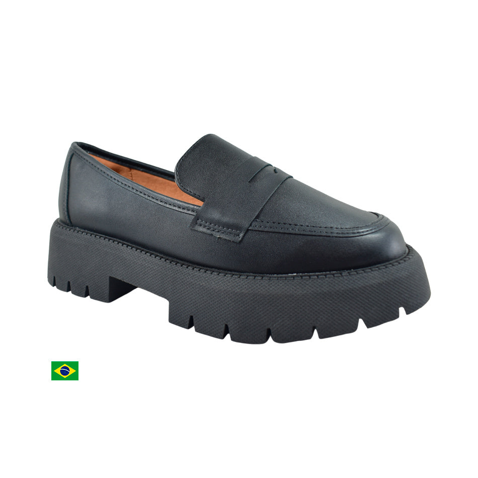 Product shot of a Brazilian-made black leather penny loafer featuring a chunky platform sole a subtle stitch detail and a soft inner lining