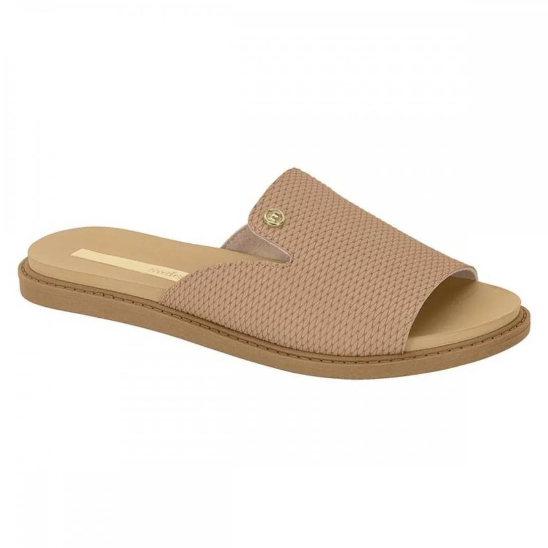Product shot of a beige Grendene slide sandal featuring a textured woven upper a gold logo and a flat brown sole