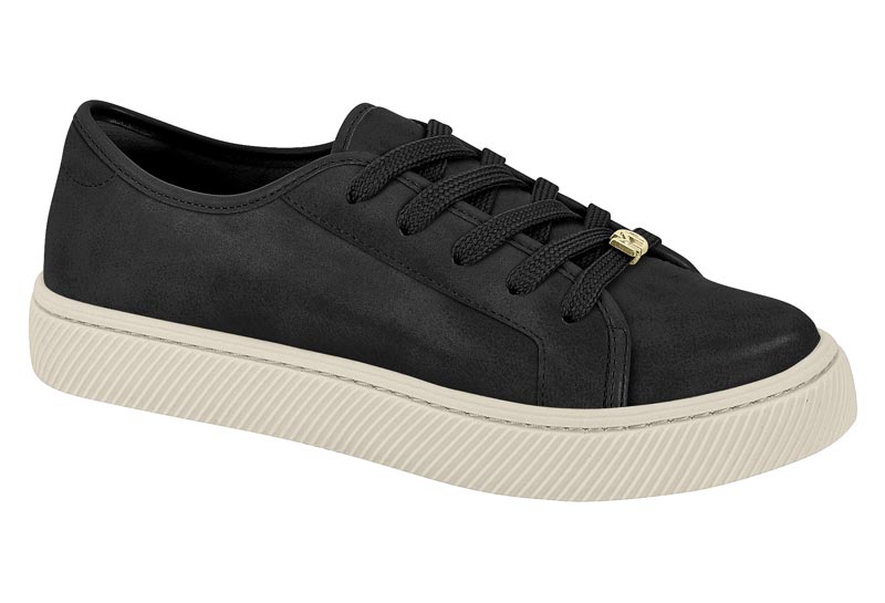 Product shot of a black suede sneaker with off-white sole and gold aglets showcasing textured fabric and a ribbed sole