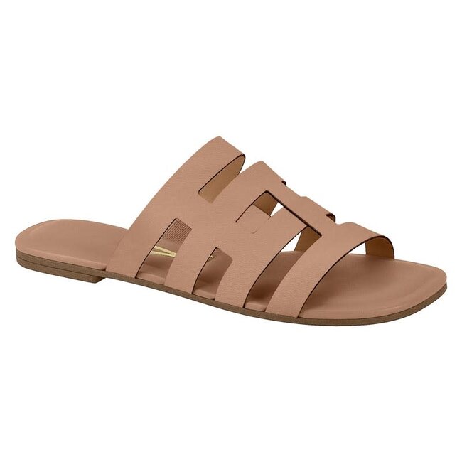 Product shot of a dusty rose colored, cutout slide sandal featuring a flat sole and geometric cutouts across the top