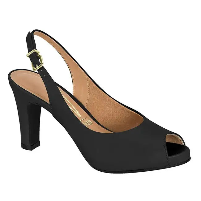 Product shot of a black peep-toe slingback high-heeled shoe featuring a gold buckle and a cushioned insole with a slight platform