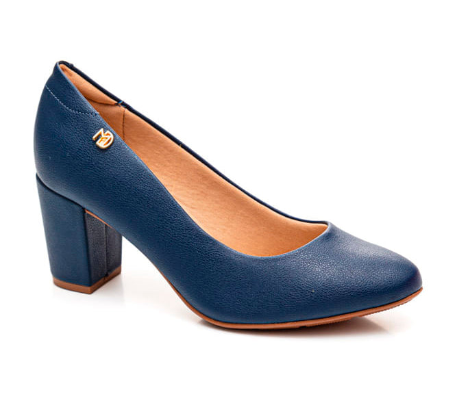 Product shot of a navy blue women's block heel pump featuring a gold logo and tan insole against a white background
