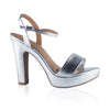Product shot of a silver metallic platform sandal with ankle strap and chunky heel showing a subtle textured finish and a light brown insole
