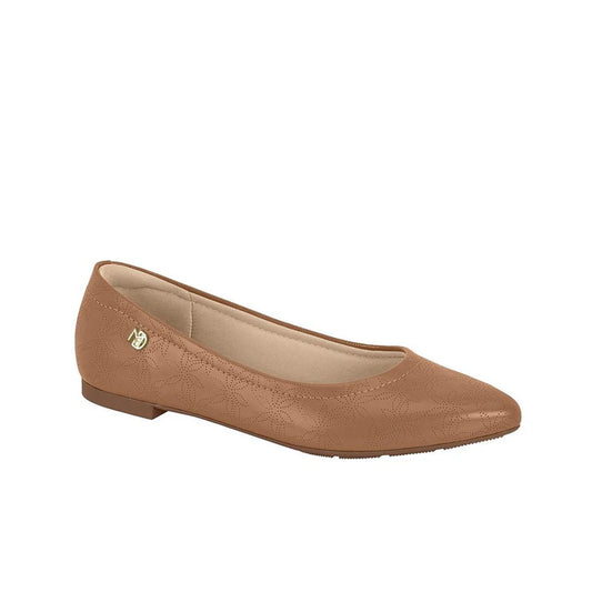 Product shot of a brown leather flat shoe with subtle floral embossing and a gold logo featuring a beige interior and a slightly pointed toe
