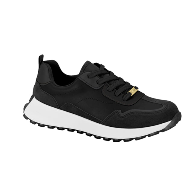 Product shot of a black sneaker with white sole and gold accent featuring a textured upper and chunky outsole
