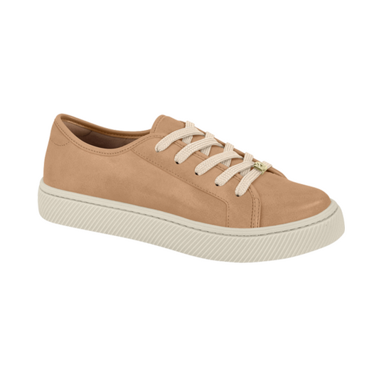 Product shot of a beige suede women's sneaker with cream laces and a ridged sole featuring a gold-toned accent
