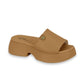 Product shot of a tan Modare platform slide sandal featuring a gold logo and a chunky sole
