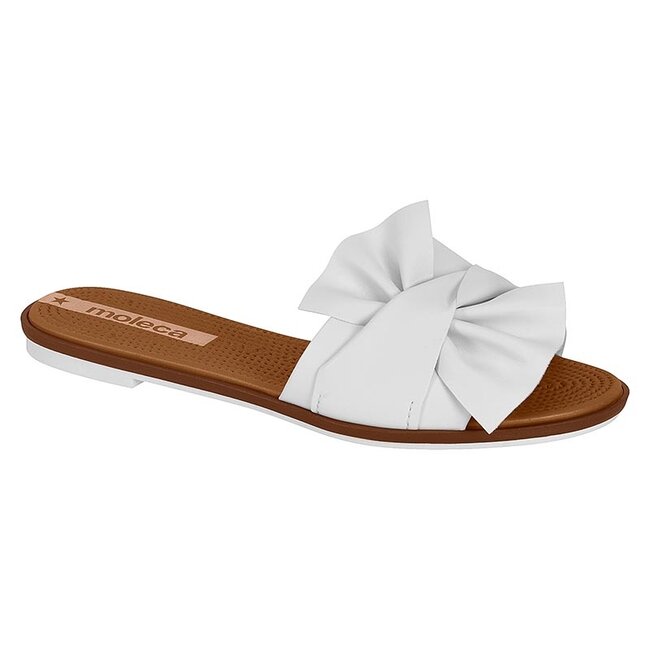 Moleca white leather slide sandal featuring a large, knotted bow detail, a brown sole and a textured footbed
