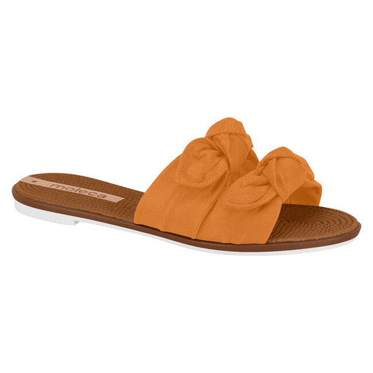 Moleca orange suede slide sandals feature double top knots a brown and white sole and a subtle textured design
