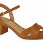 Product shot of a Vizzano brand camel-colored low heeled sandal featuring a gold buckle ankle strap and crisscross toe straps  with a subtle textured finish
