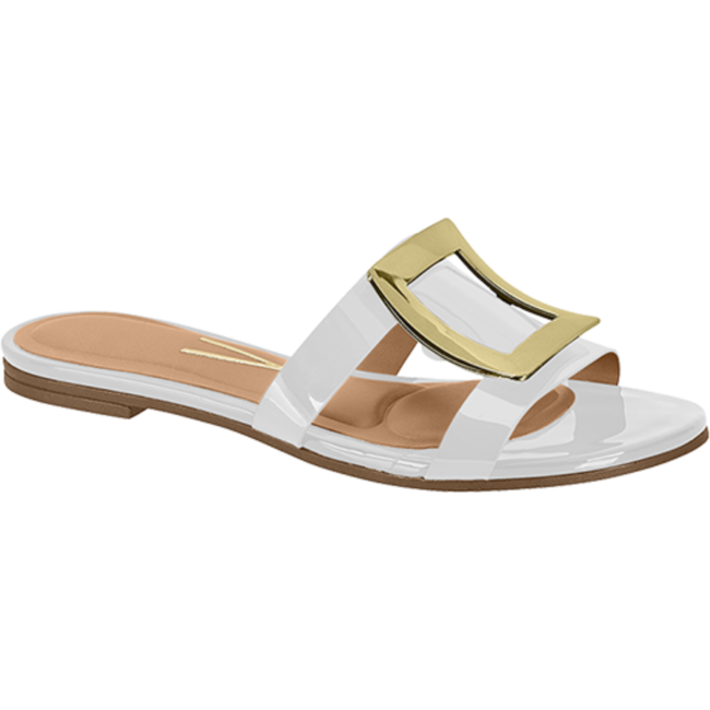Product shot of a white patent leather sandal with a gold buckle featuring a beige insole and a flat sole

