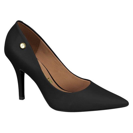 Product shot of a black women's pointed-toe high-heel pump featuring a gold logo detail and a light brown insole against a white background
