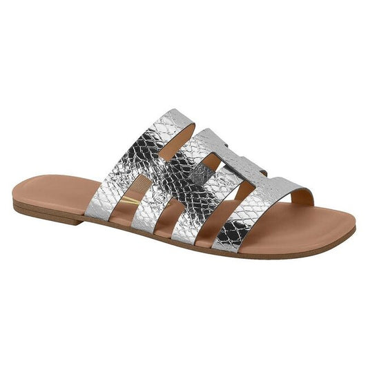 Silver metallic snakeskin slide sandal with a cutout design featuring a neutral-toned sole and thin gold accents
